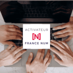 Quatre mains autour d'un ordinateur portable avec le logo Activateur France Num au centre - WenDev